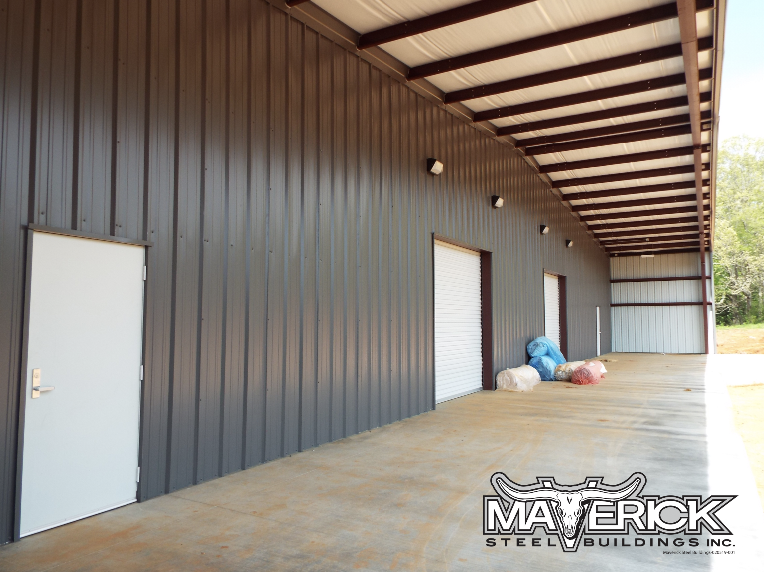 Pre Engineered Metal Building With Covered Outdoor Space, Lighting, And Roll Up Doors