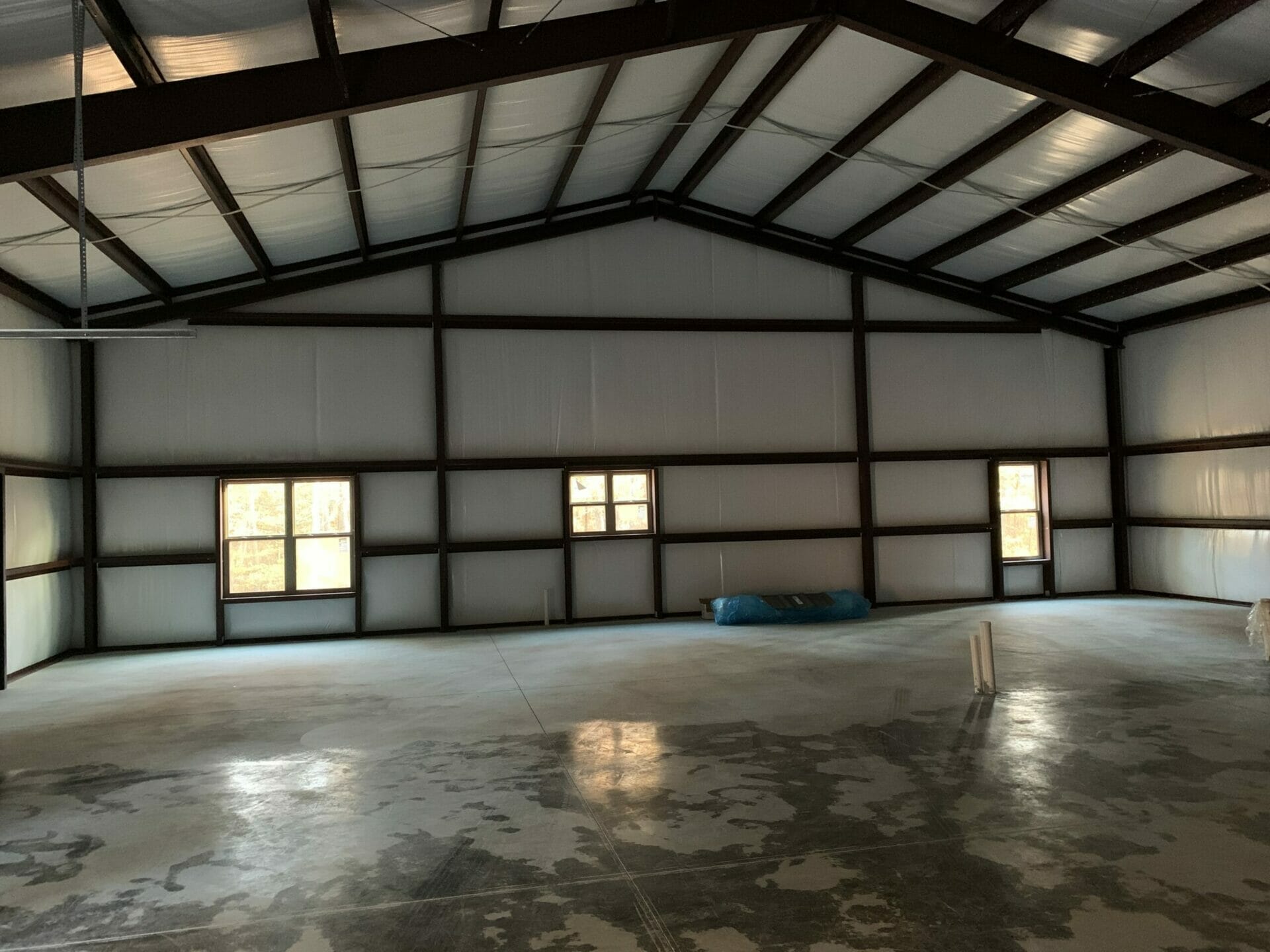 Interior View Of Pre-Engineered Metal Building With High Clearance Steel Beams And Custom Windows