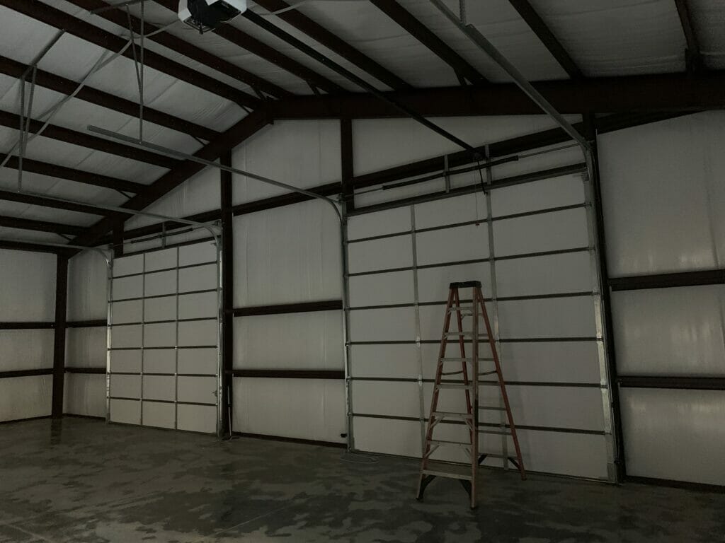 Interior View Of Pre-Engineered Metal 2 Car Garage Building With Roll Up Garage Doors