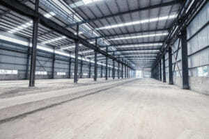 Large Pre-Engineered Metal Building Interior With Lighting And Steel Beams