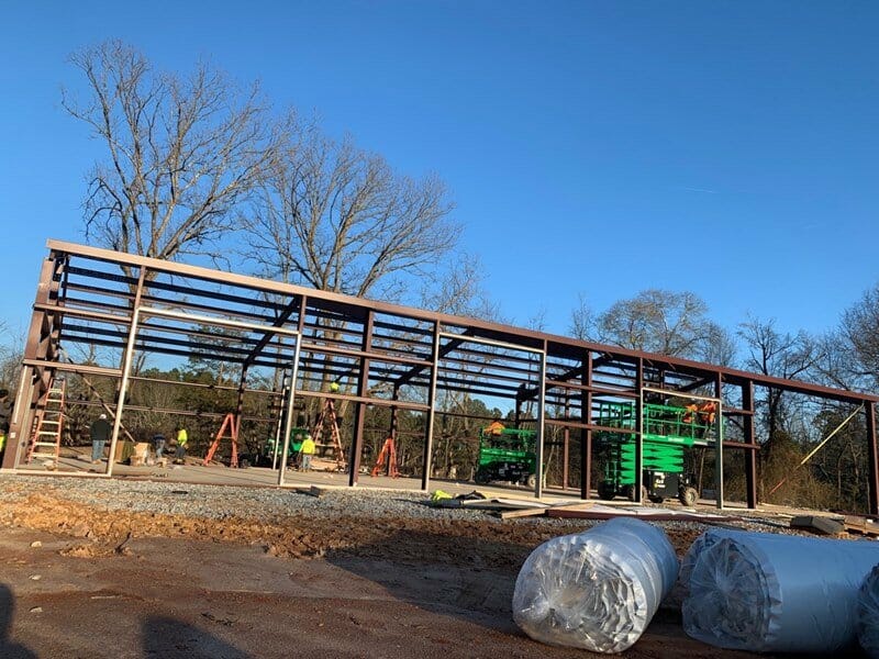 Workers Contrusting a Pre Engineered Steel Building Kit