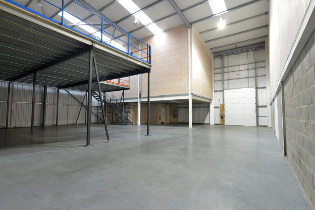 interior view of empty warehouse steel building and mezzanine floor